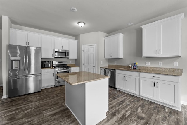 kitchen featuring appliances with stainless steel finishes, a center island, and white cabinets