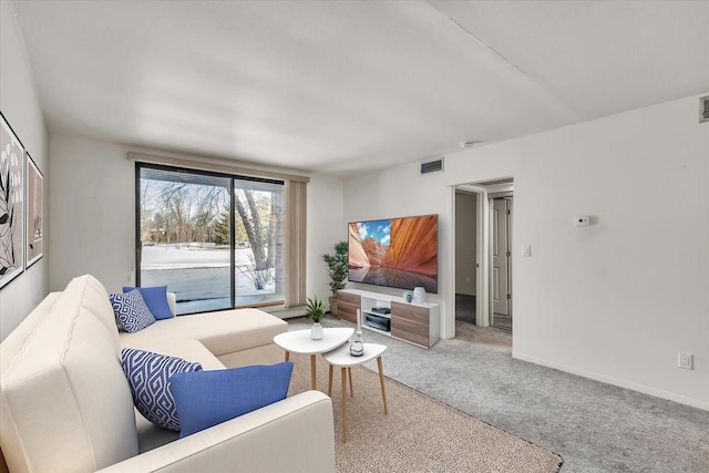 carpeted living room with visible vents and baseboards