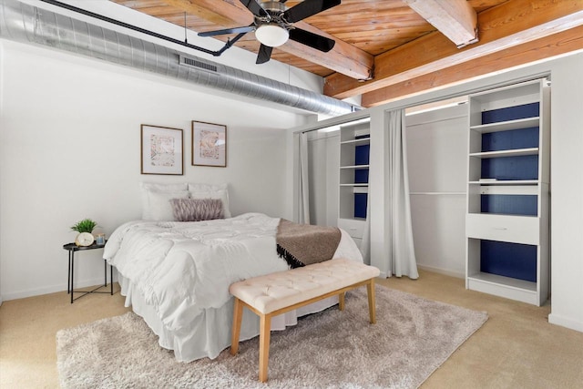 bedroom featuring light carpet, baseboards, visible vents, and beam ceiling