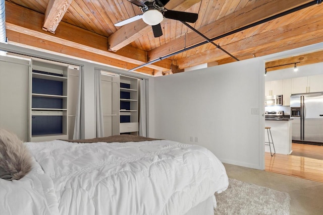 bedroom featuring wood ceiling, stainless steel refrigerator with ice dispenser, and beam ceiling