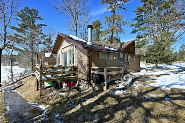 view of snow covered exterior featuring a deck