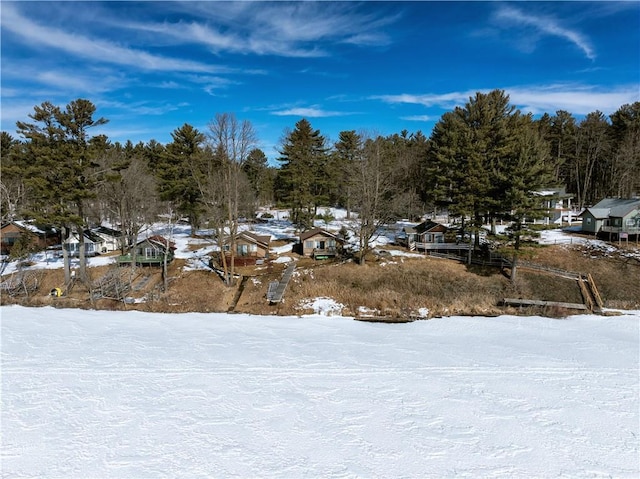 yard covered in snow featuring a residential view