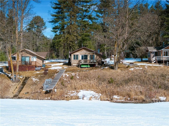 view of front of home with stairway and a wooden deck