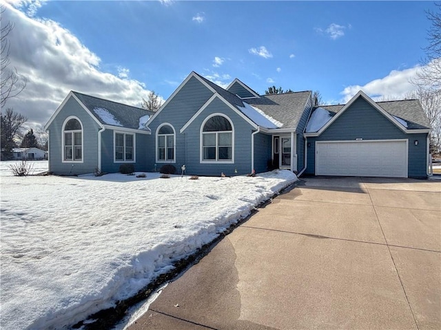 single story home featuring concrete driveway and an attached garage