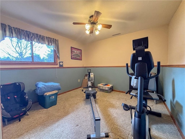 exercise room with carpet floors, visible vents, baseboards, and a ceiling fan