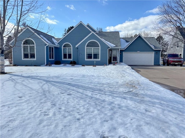 ranch-style house with a garage, driveway, and roof with shingles