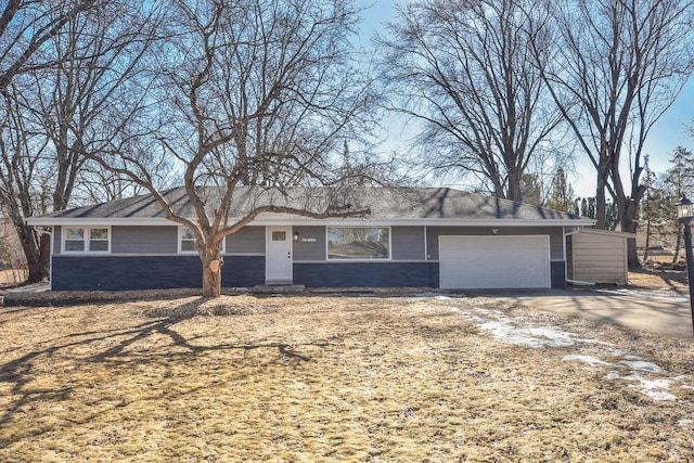 single story home featuring an attached garage and driveway