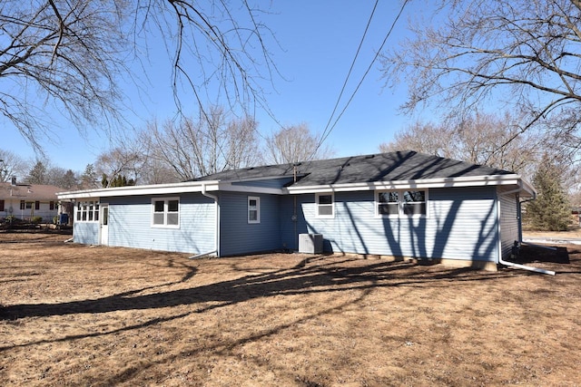 back of property featuring a lawn