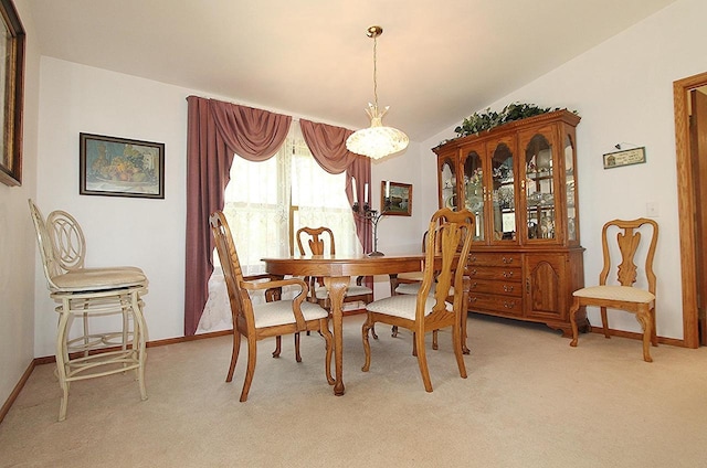 dining room with light carpet and baseboards