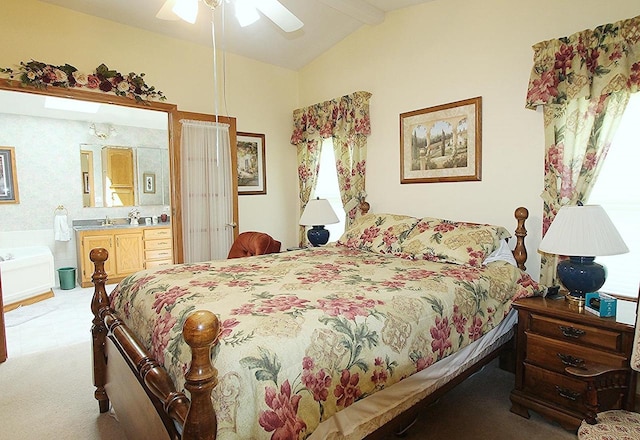 bedroom featuring vaulted ceiling with beams, ceiling fan, and connected bathroom