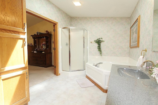 full bath featuring a garden tub, a stall shower, a sink, and wallpapered walls