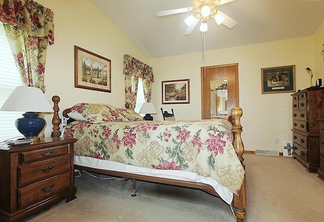 bedroom featuring light carpet, visible vents, baseboards, a ceiling fan, and vaulted ceiling