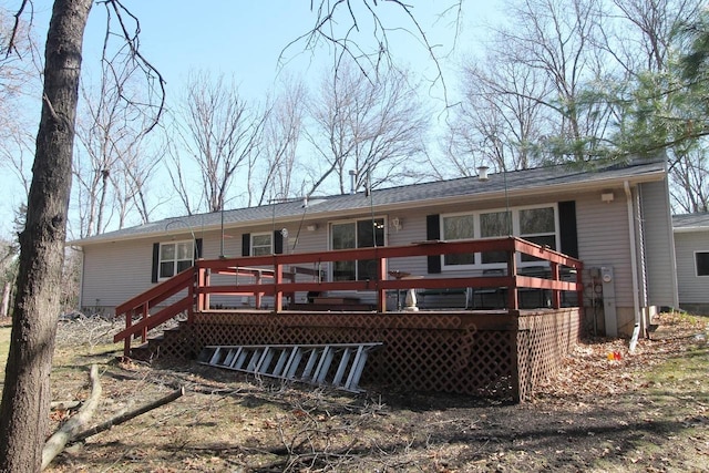 rear view of house featuring a deck