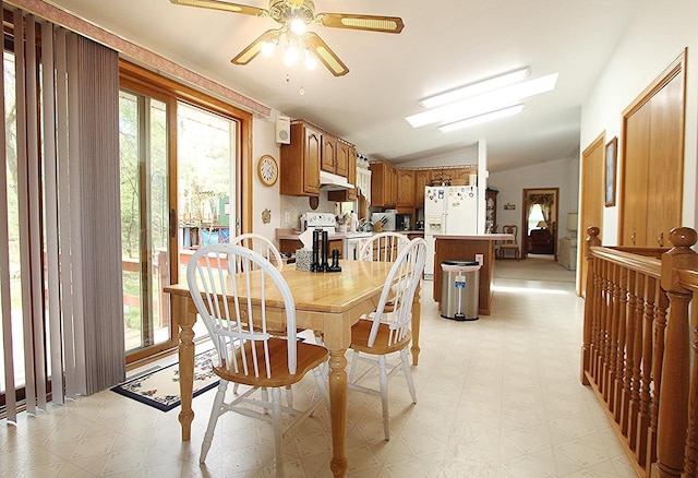 dining area featuring vaulted ceiling, light floors, and ceiling fan