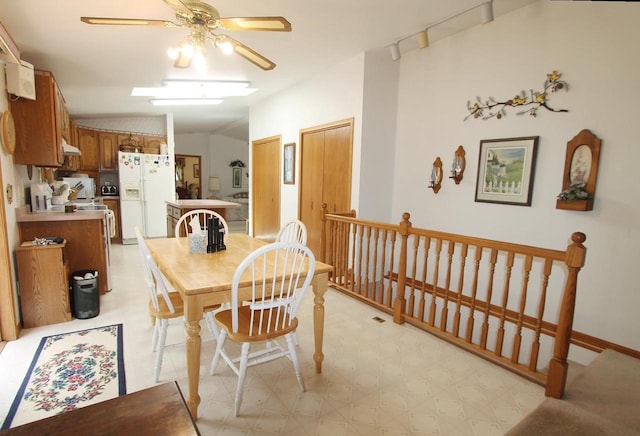 dining area with lofted ceiling, light floors, and ceiling fan