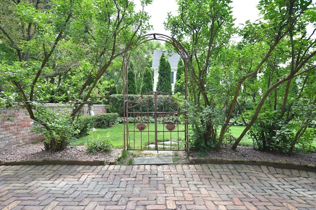 view of gate with a yard and fence