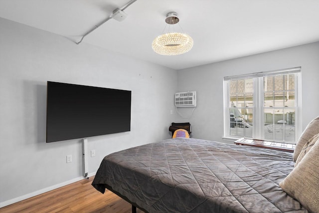 bedroom with baseboards and wood finished floors