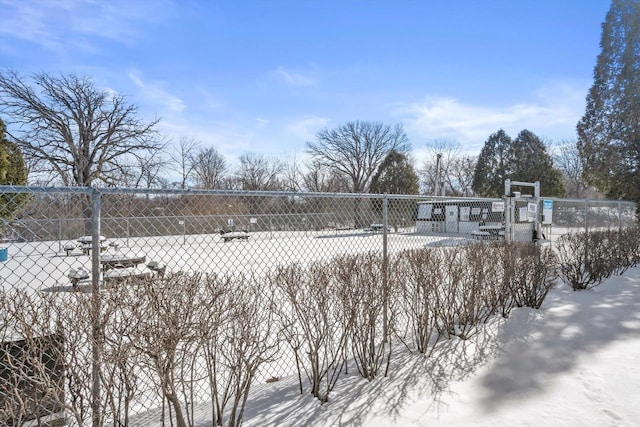 yard layered in snow featuring fence