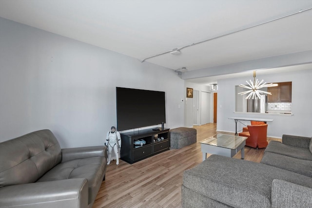 living area featuring light wood-style floors and a chandelier