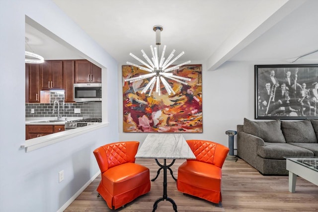 living area featuring a chandelier and wood finished floors