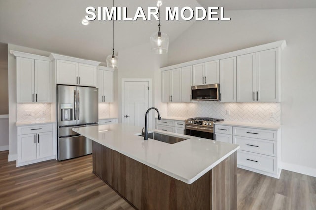 kitchen featuring an island with sink, white cabinetry, appliances with stainless steel finishes, and a sink