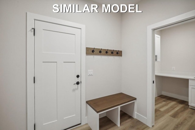 mudroom with baseboards and light wood-style floors