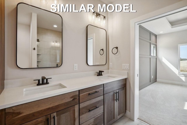 bathroom with double vanity, recessed lighting, a sink, and baseboards