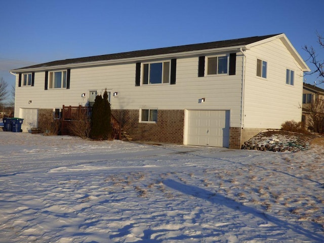 view of front of house featuring a garage and brick siding