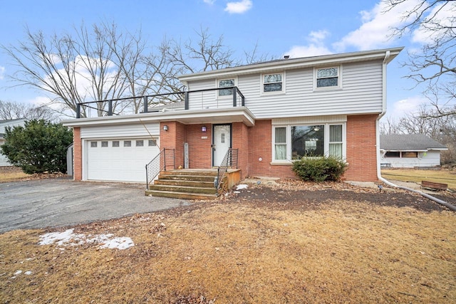 view of front of house with brick siding, driveway, a balcony, and an attached garage