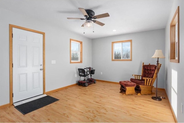 sitting room featuring ceiling fan, baseboards, and wood finished floors