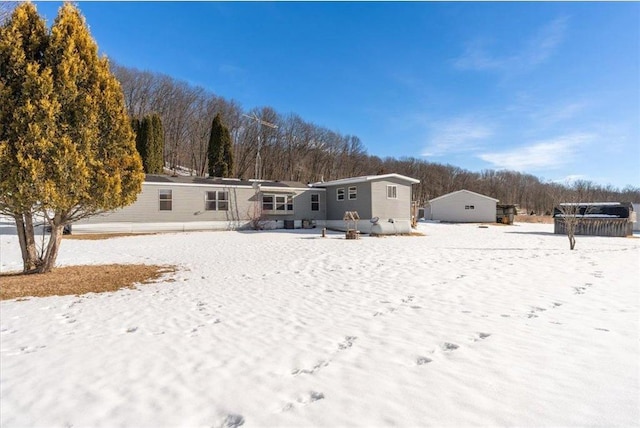 view of snow covered rear of property