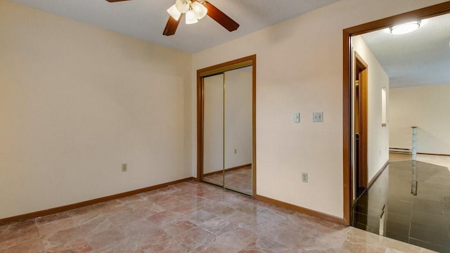 unfurnished bedroom with a ceiling fan, a closet, and baseboards