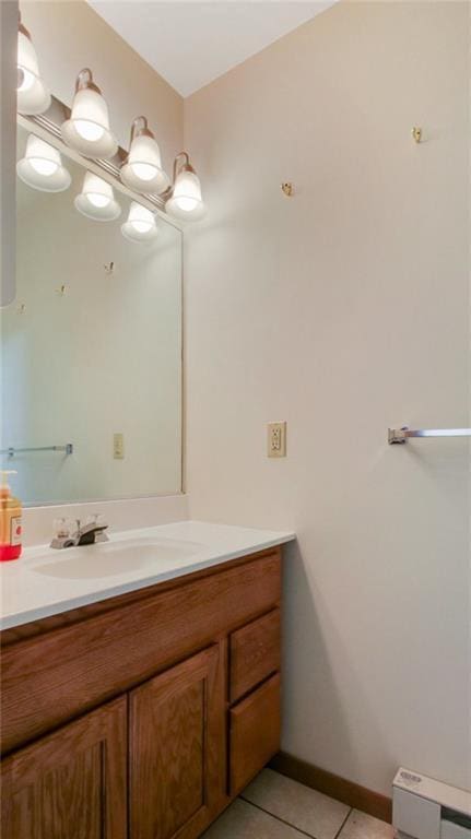 bathroom featuring tile patterned flooring, baseboards, and vanity