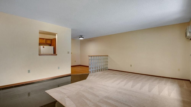 unfurnished room with a textured ceiling and baseboards