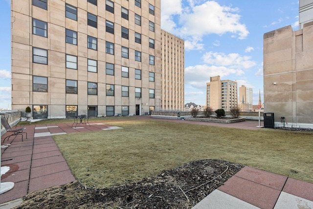 view of property's community with a city view and a yard