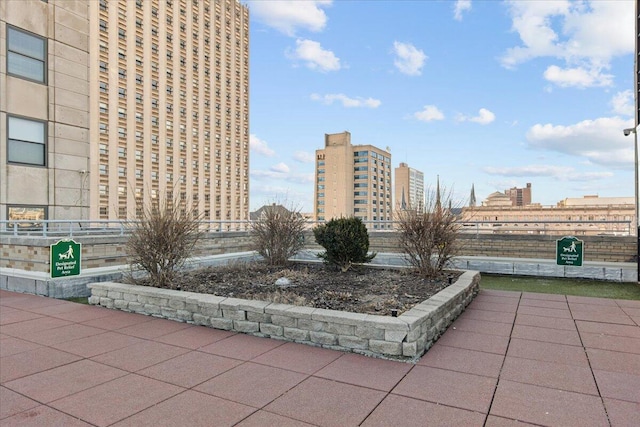 view of property's community with a view of city and fence