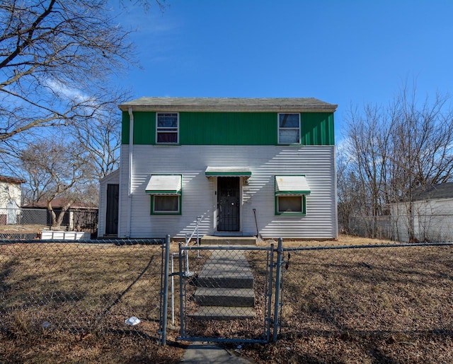 traditional-style house with a fenced front yard and a gate