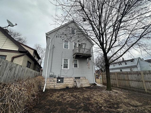 rear view of property with fence