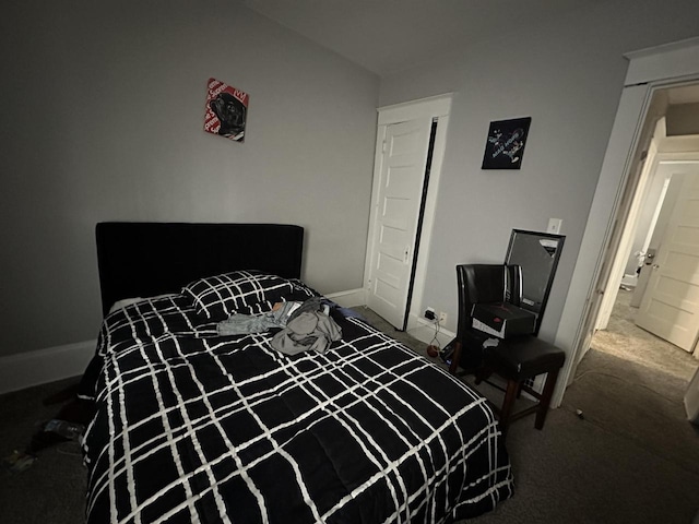 bedroom featuring carpet and baseboards