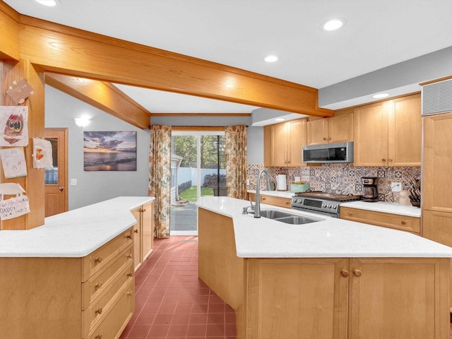 605 S Adams Ave, Marshfield, WI 54449 - kitchen featuring stainless steel appliances, a sink, light countertops, decorative backsplash, and an island with sink
