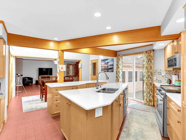 605 S Adams Ave, Marshfield, WI 54449 - kitchen with appliances with stainless steel finishes, light countertops, a sink, and an island with sink