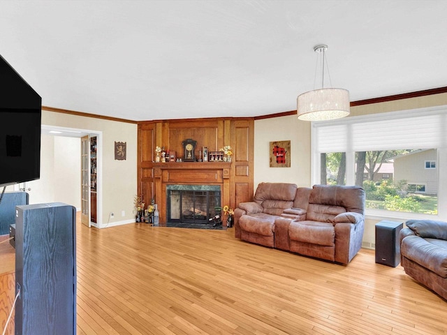 605 S Adams Ave, Marshfield, WI 54449 - living area with light wood finished floors, baseboards, crown molding, and a high end fireplace