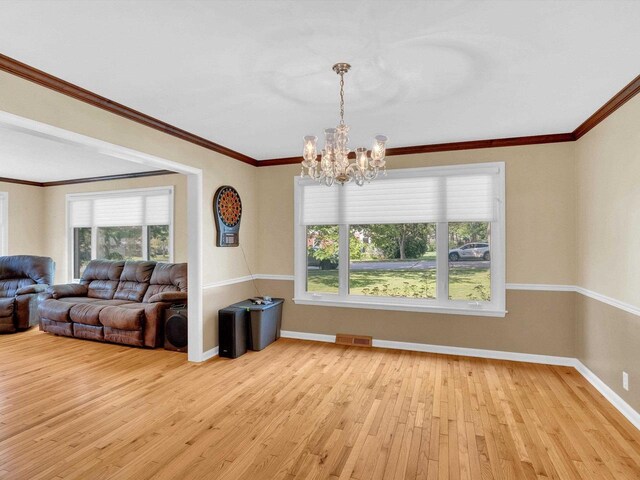 605 S Adams Ave, Marshfield, WI 54449 - dining space featuring baseboards, light wood finished floors, a chandelier, and a healthy amount of sunlight