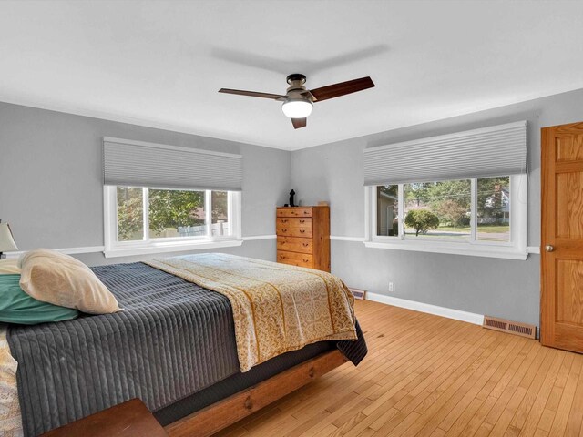 605 S Adams Ave, Marshfield, WI 54449 - bedroom featuring light wood-style flooring, multiple windows, visible vents, and baseboards
