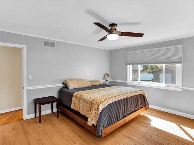 605 S Adams Ave, Marshfield, WI 54449 - bedroom featuring ornamental molding, light wood-type flooring, visible vents, and baseboards
