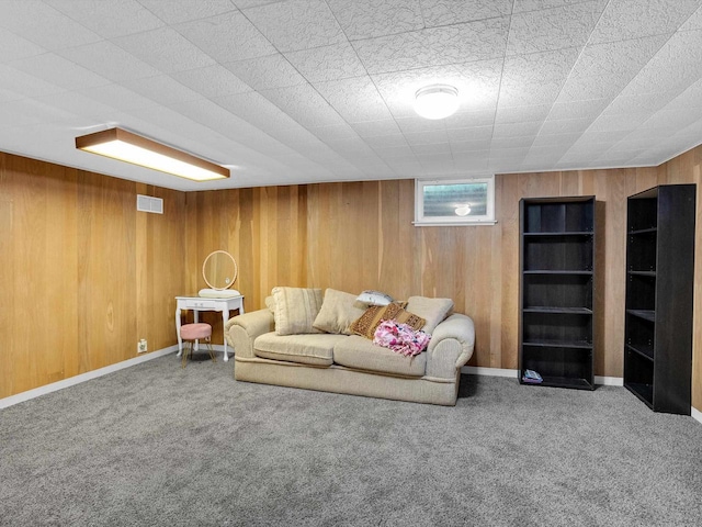 605 S Adams Ave, Marshfield, WI 54449 - living area featuring carpet, visible vents, wood walls, and baseboards