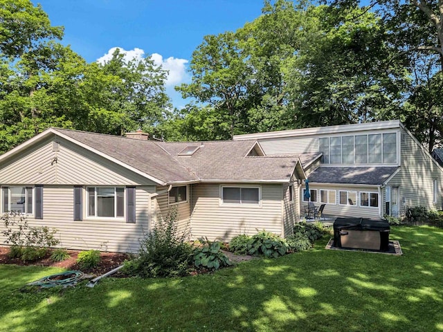 605 S Adams Ave, Marshfield, WI 54449 - view of front facade with roof with shingles, a hot tub, and a front lawn