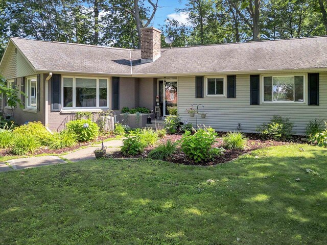 605 S Adams Ave, Marshfield, WI 54449 - single story home featuring a shingled roof, a front yard, brick siding, and a chimney