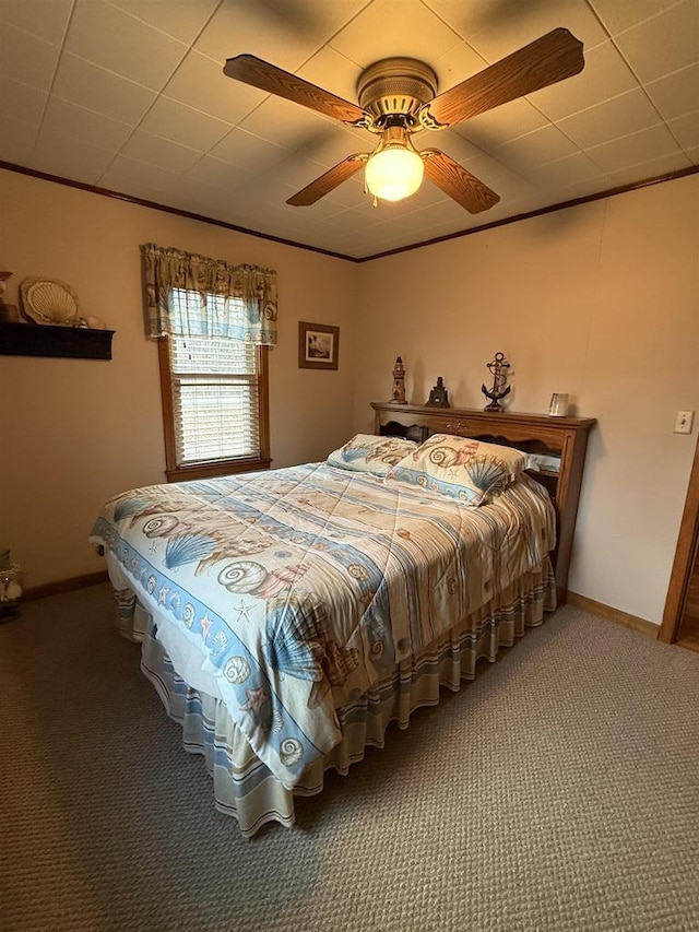 bedroom featuring carpet, baseboards, ceiling fan, and ornamental molding