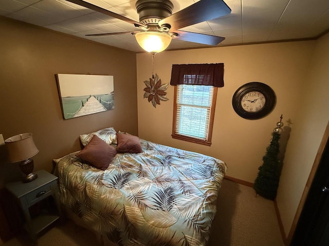 carpeted bedroom with a ceiling fan and baseboards